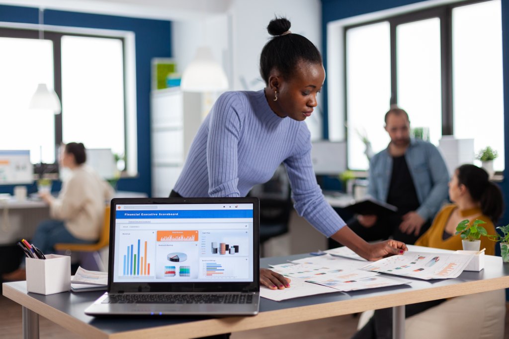 African startup entrepreneur and diverse team analyzing digital marketing reports, SEO performance, and online advertising statistics